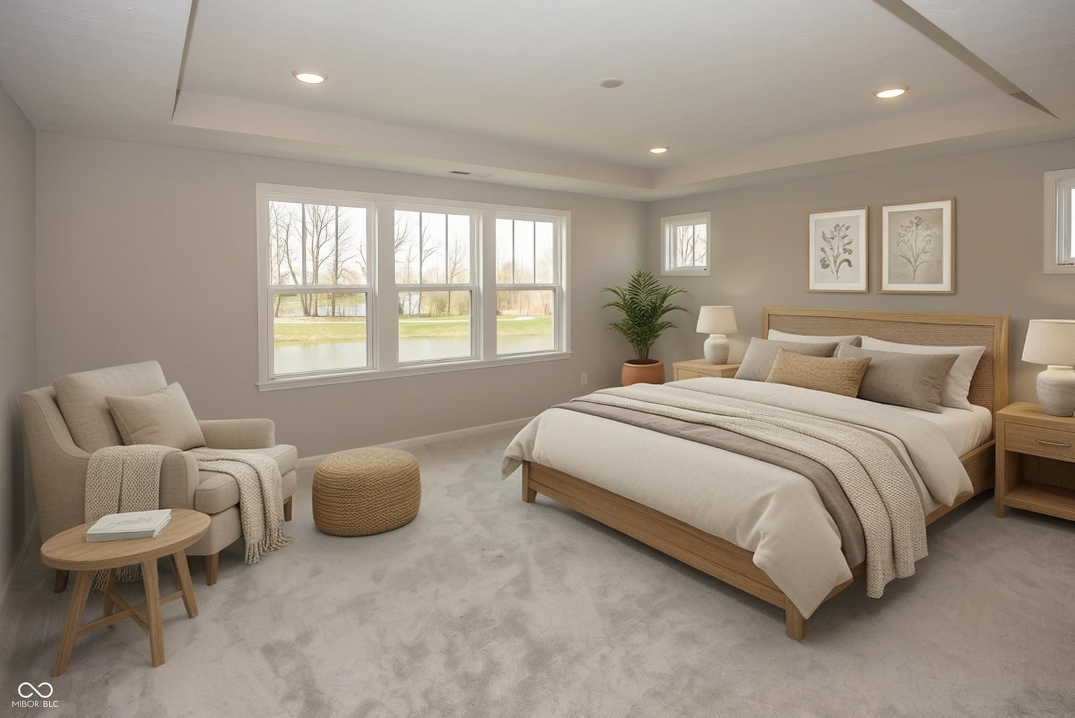 Spacious primary suite with abundant natural light and seating area.