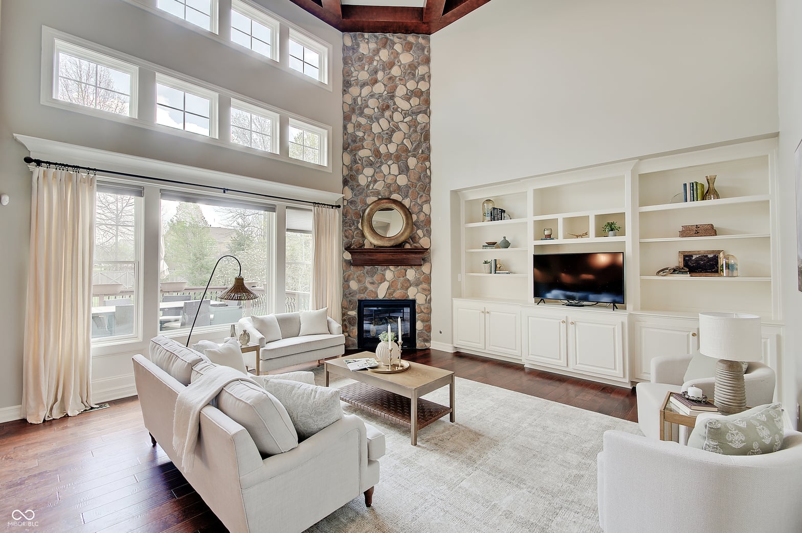 Bright living room with fireplace and built-in entertainment center.