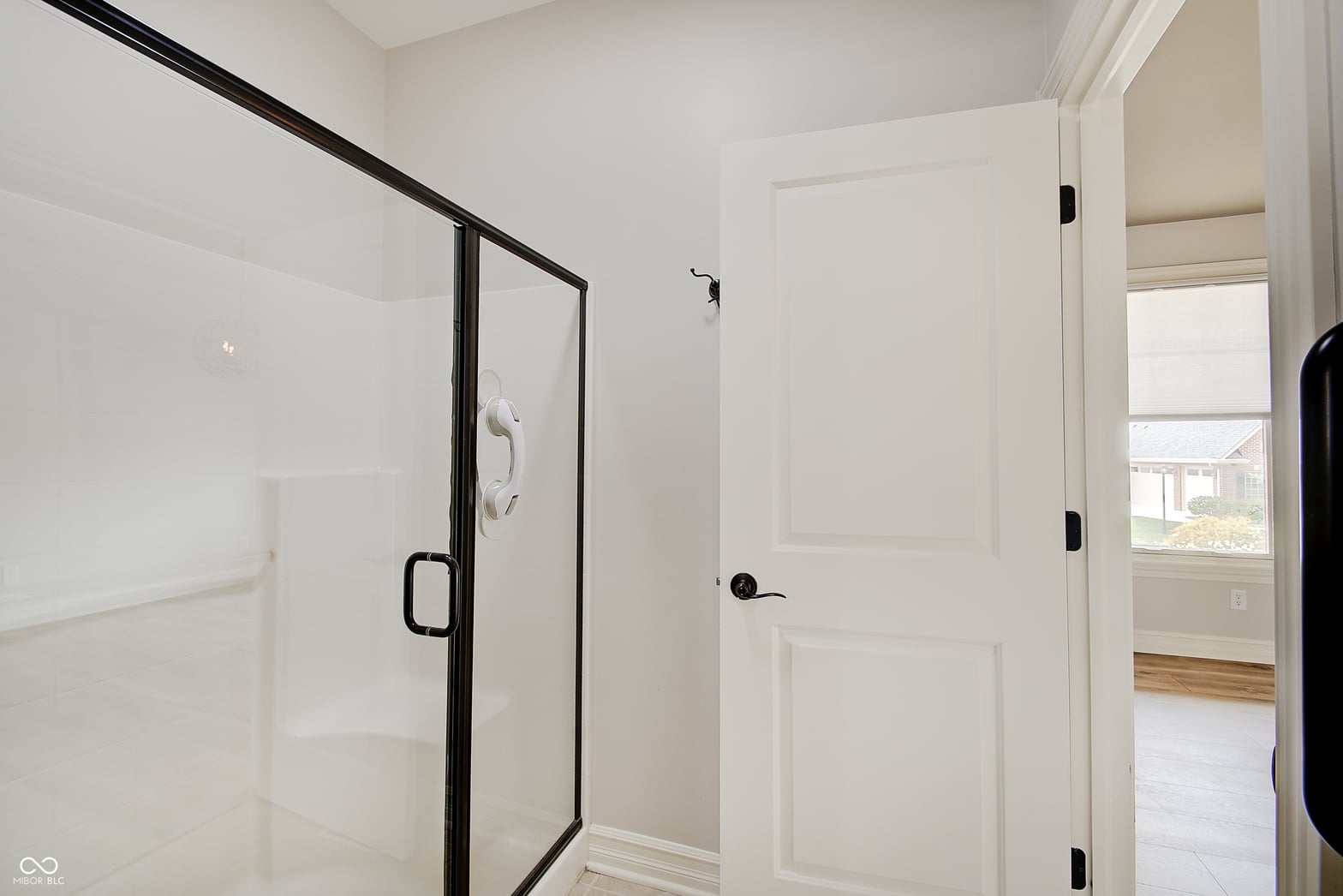 Luxurious walk-in shower with sleek black frame design.