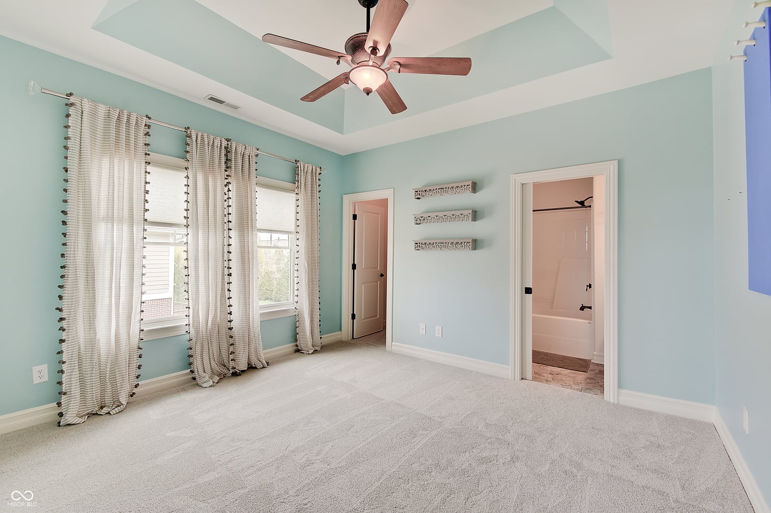 Bright primary suite with tray ceiling and ensuite access.