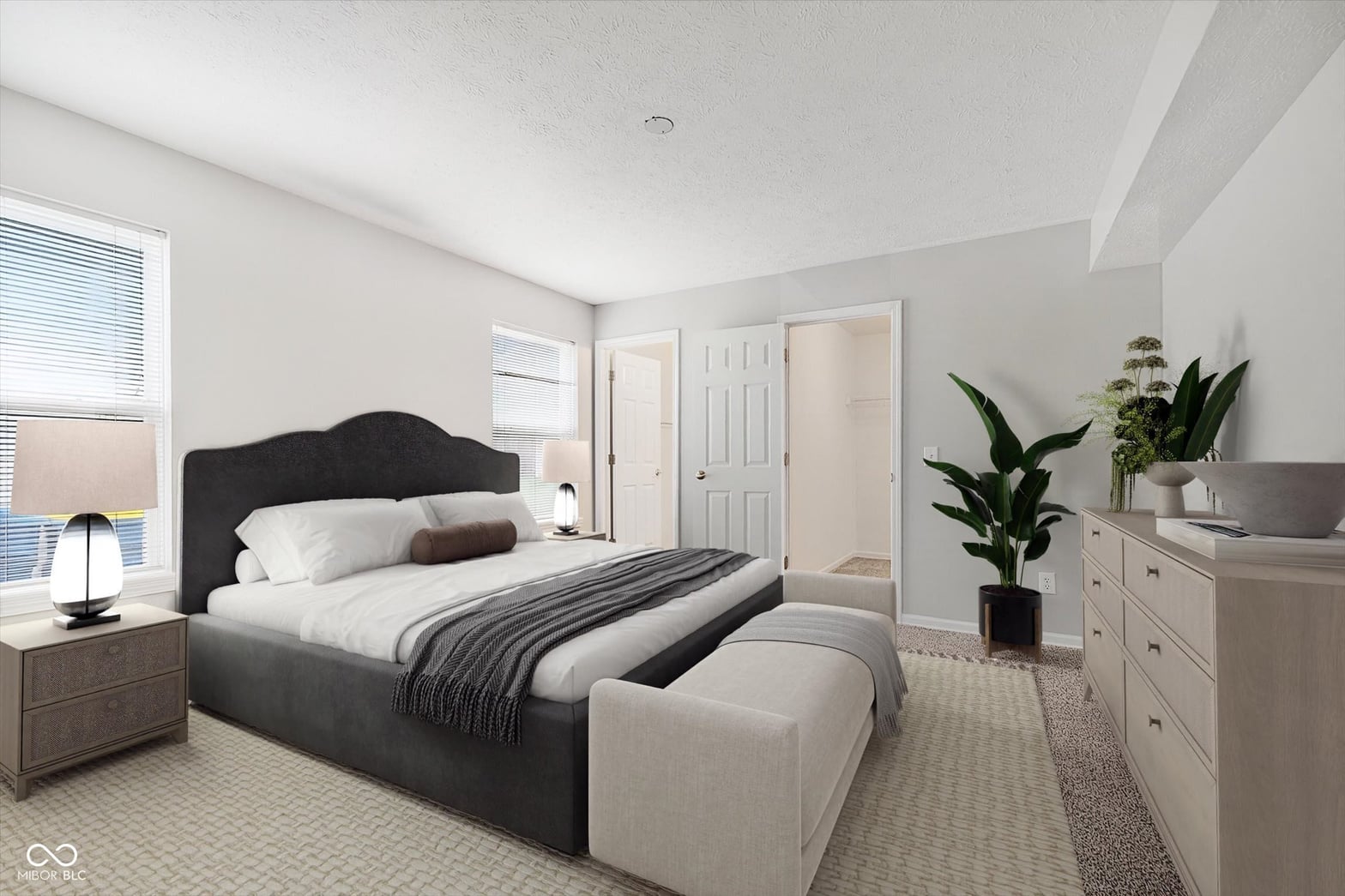 Spacious primary bedroom with neutral design and ample storage.