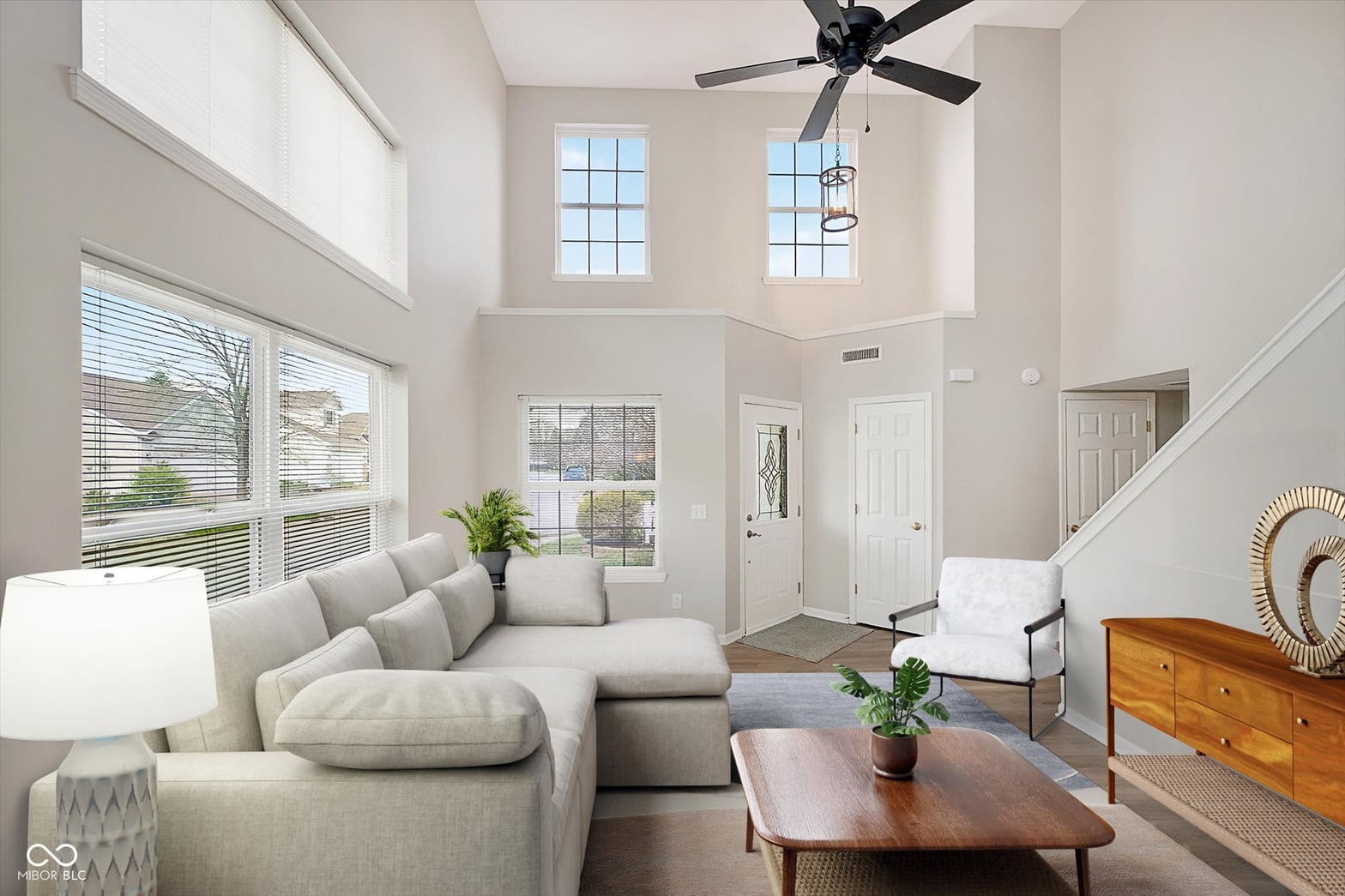 Bright two-story living room with abundant natural light.