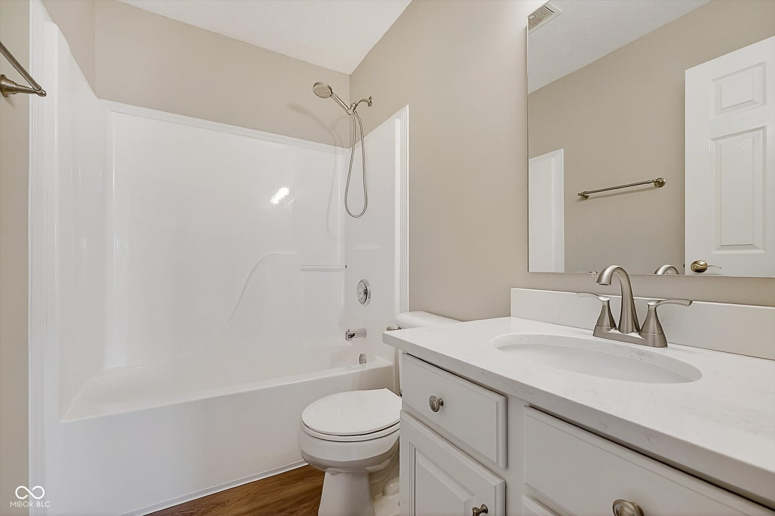 Spacious primary bath with double vanity and soaking tub.