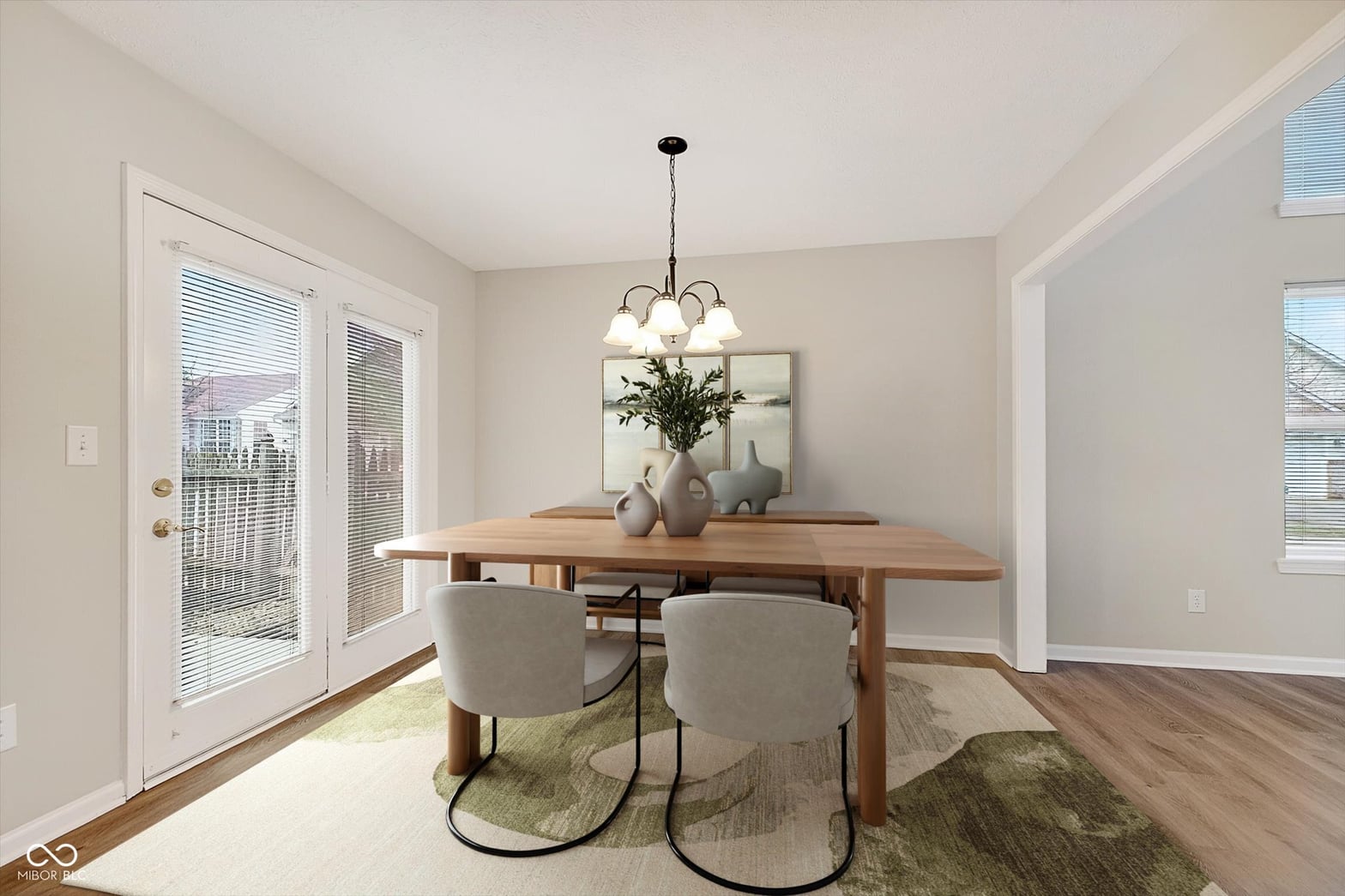 Bright dining room with French doors and natural light.