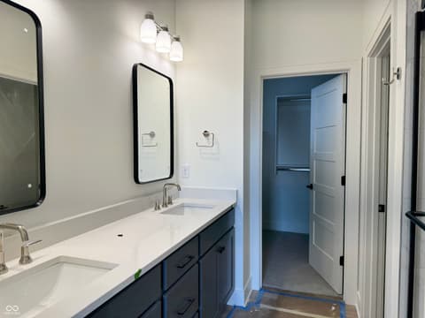 Primary bathroom at 16533 Iron Tree Court, Westfield, IN — Spa-like primary bath with dual vanity and walk-in closet.