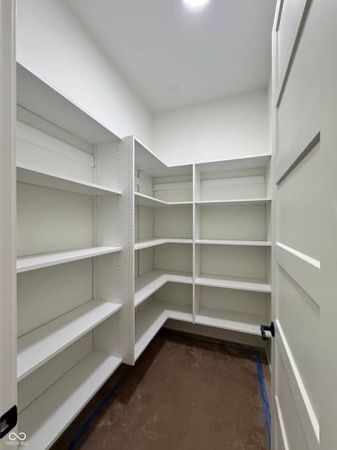 Pantry at 16533 Iron Tree Court, Westfield, IN — Pristine walk-in pantry with extensive white shelving.