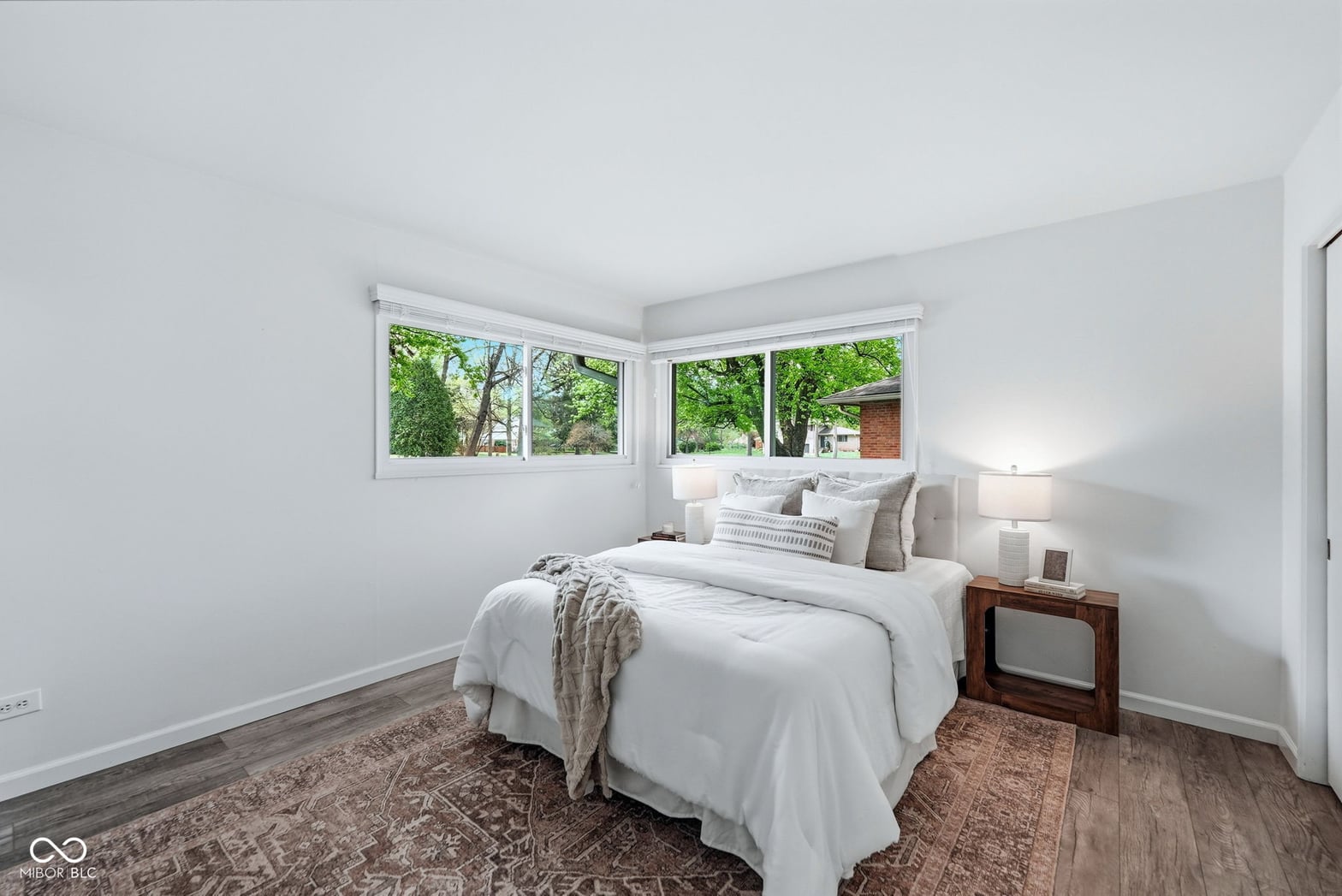 Bright corner bedroom with abundant natural light and views.