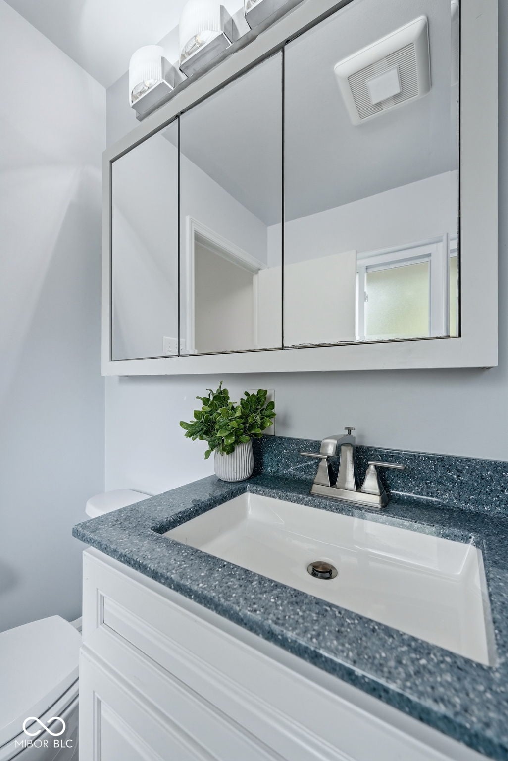 Modern primary bath with quartz counters and updated fixtures.