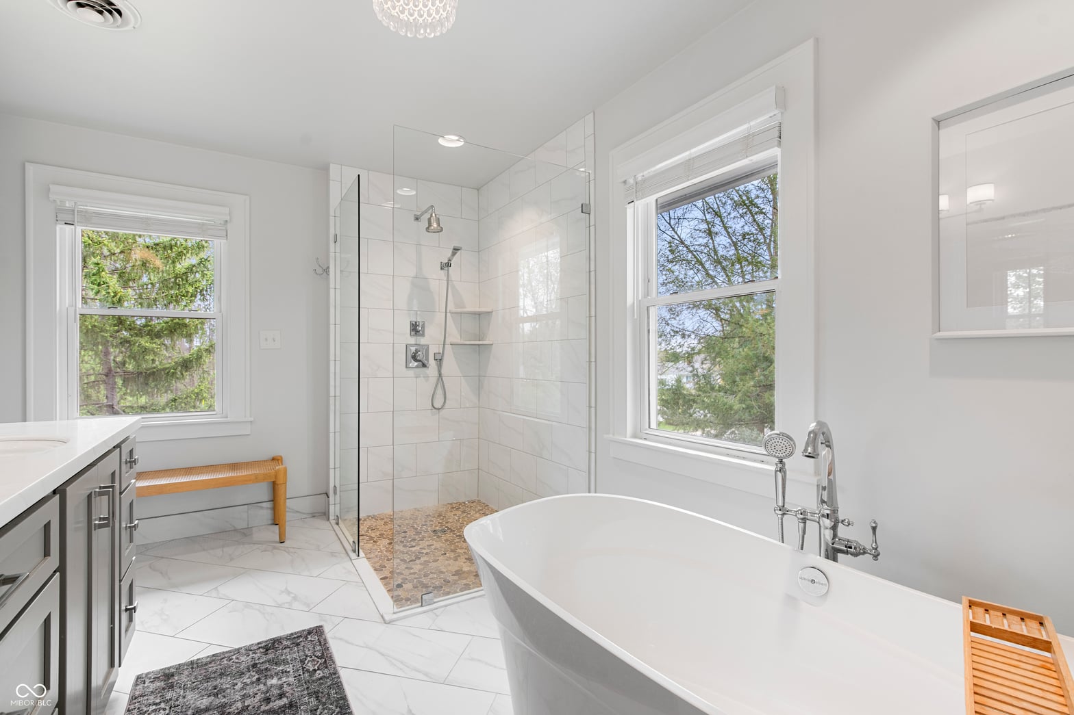 Spa-like primary bath with freestanding tub and walk-in shower.