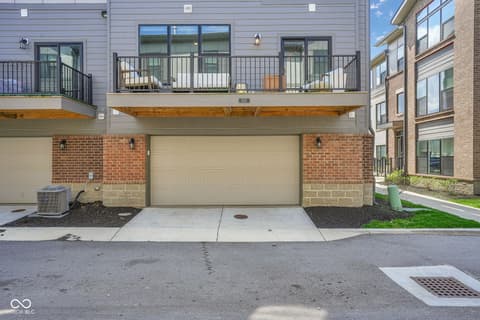Front exterior at 659 Langford Street, Carmel, IN — Modern townhouse with two-car garage and spacious deck.