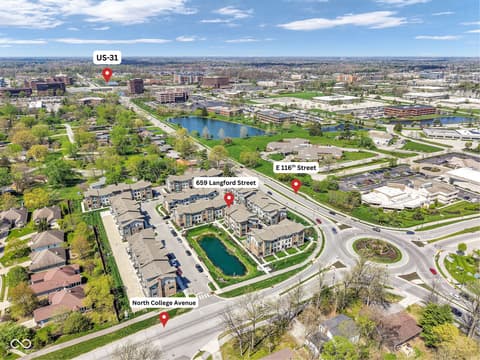 Aerial view at 659 Langford Street, Carmel, IN — New construction mixed-use development with central pond.