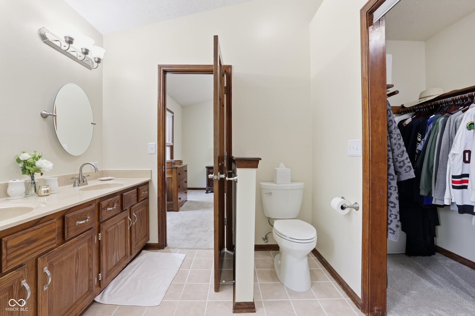 Spacious primary bath with dual vanity and separate toilet area.