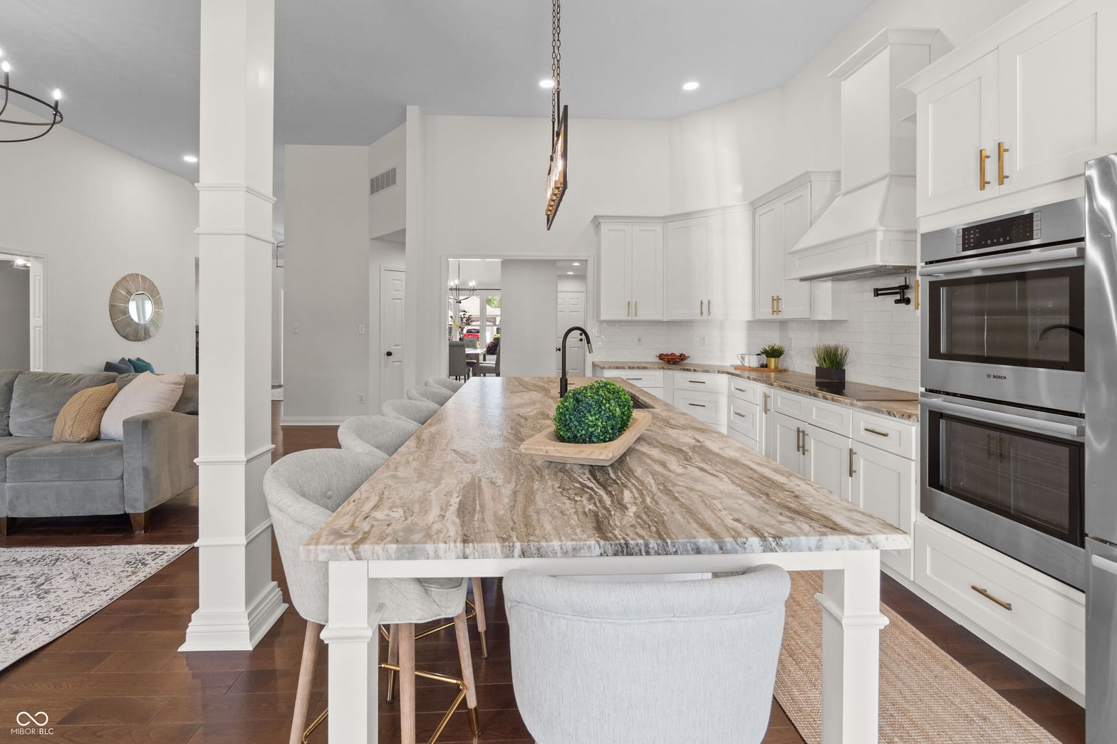 Luxurious modern kitchen with marble waterfall island.