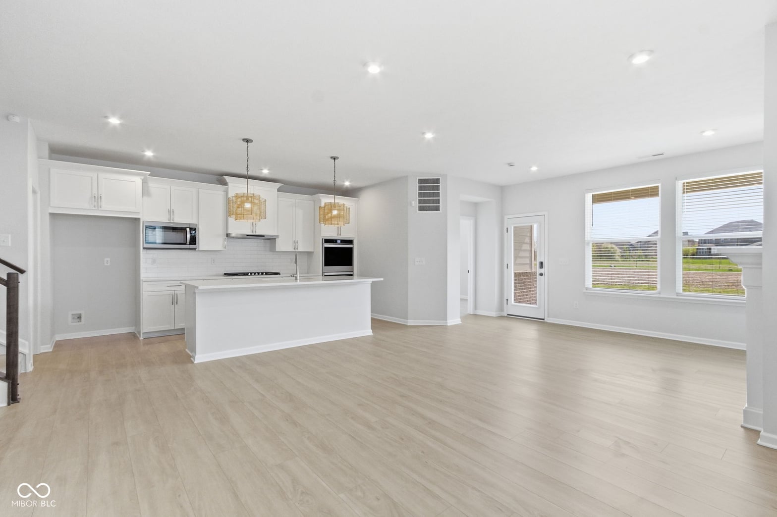 Bright open-concept kitchen with modern white cabinetry and premium finishes.