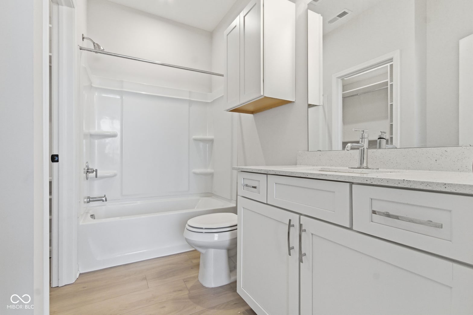 Bright modern primary bath with floating vanity and quartz.