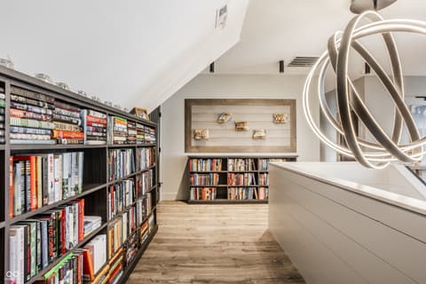 Bonus room at 13120 Broad Street, Carmel, IN — Custom media room with built-in shelving and modern design.