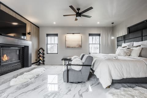 Primary bedroom at 13120 Broad Street, Carmel, IN — Luxurious primary suite with fireplace and marble floors.
