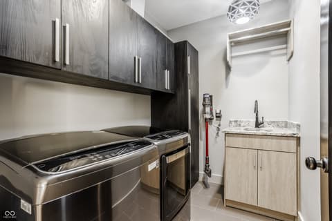 Laundry room at 13120 Broad Street, Carmel, IN — Modern laundry room with premium stainless steel appliances.