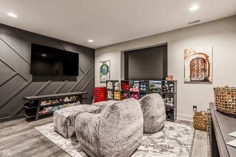 Bonus room at 13120 Broad Street, Carmel, IN — Modern entertainment space with premium storage and seating.