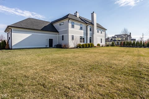 Front exterior at 13120 Broad Street, Carmel, IN — Spacious colonial home with expansive manicured yard.