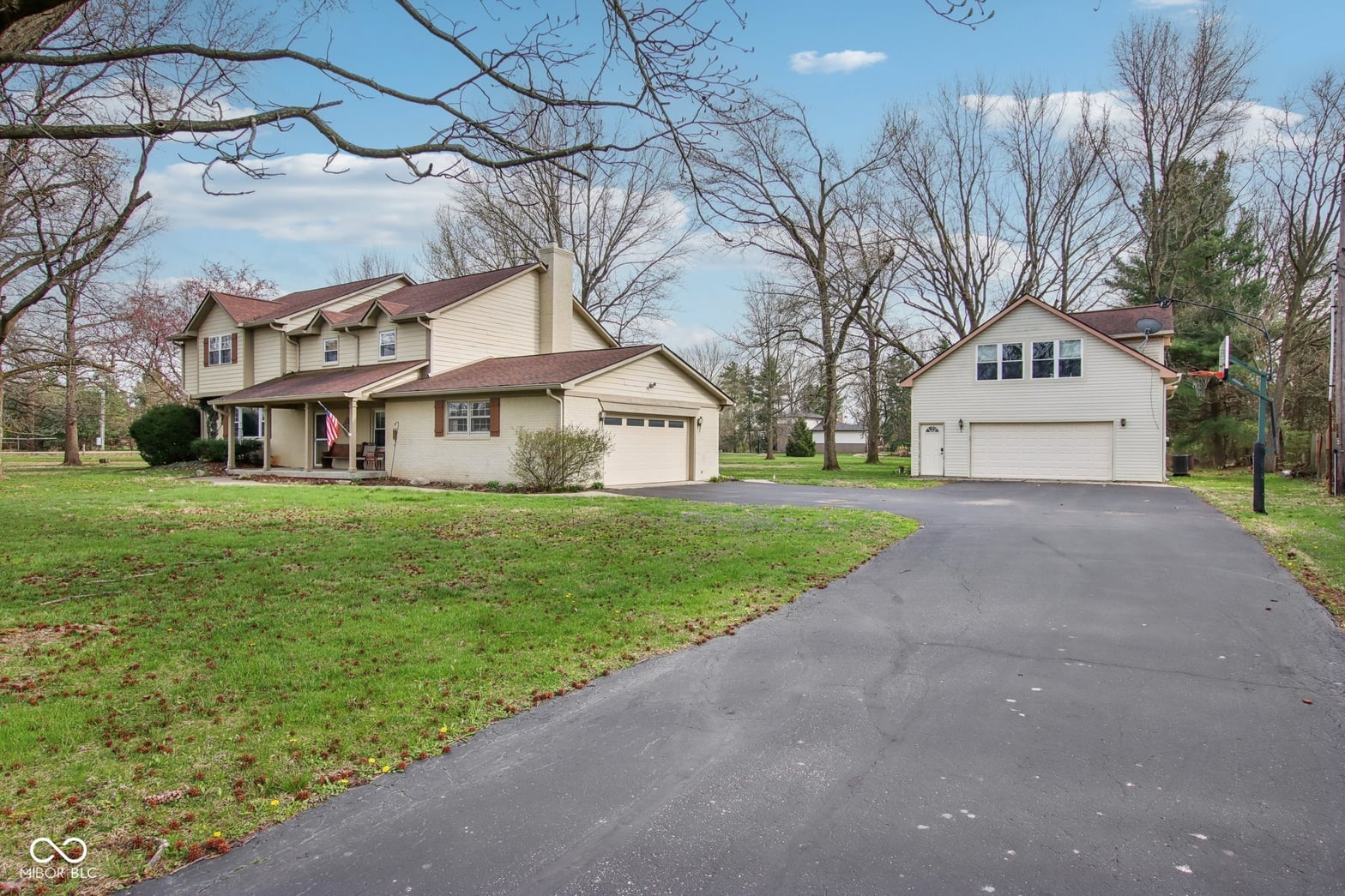 Spacious colonial with dual garages on private grounds.