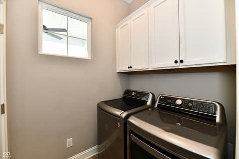 Laundry room at 9861 Bucklebury Lane, Carmel, IN — Modern laundry room with premium stainless steel appliances.