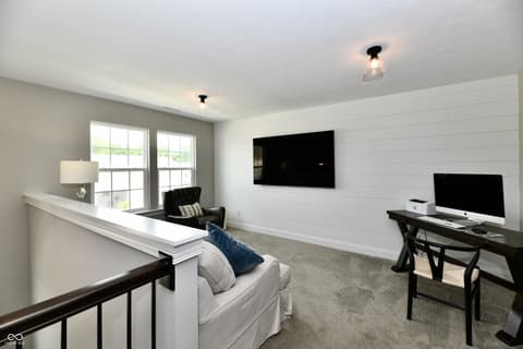Bonus room at 9861 Bucklebury Lane, Carmel, IN — Modern bonus room with shiplap walls and large windows.