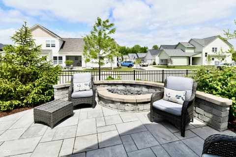 Outdoor living area at 9861 Bucklebury Lane, Carmel, IN — Stunning outdoor living space with fire pit and seating.