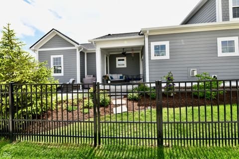 Front exterior at 9861 Bucklebury Lane, Carmel, IN — Newly built modern farmhouse with inviting covered porch.