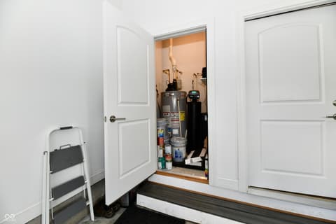 Garage at 9861 Bucklebury Lane, Carmel, IN — Well-organized garage with dedicated utility storage closet.