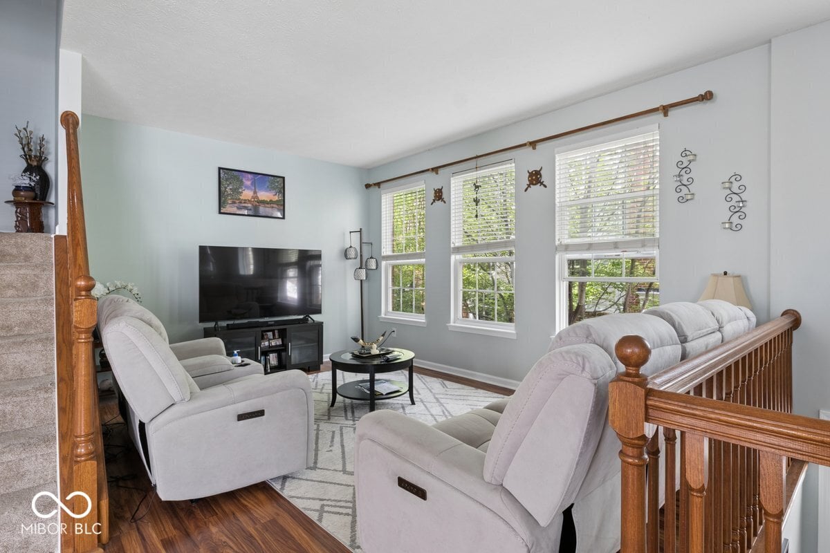 Bright family room with abundant windows and recliners.