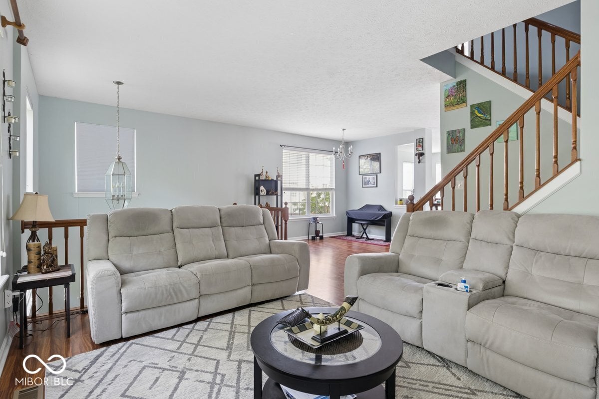 Spacious two-story living room with comfortable recliners.