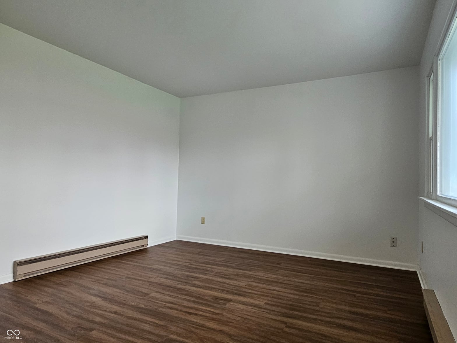 Bedroom at 100 S Blake Street, Sheridan, IN — Bright bedroom with hardwood floors and fresh paint.