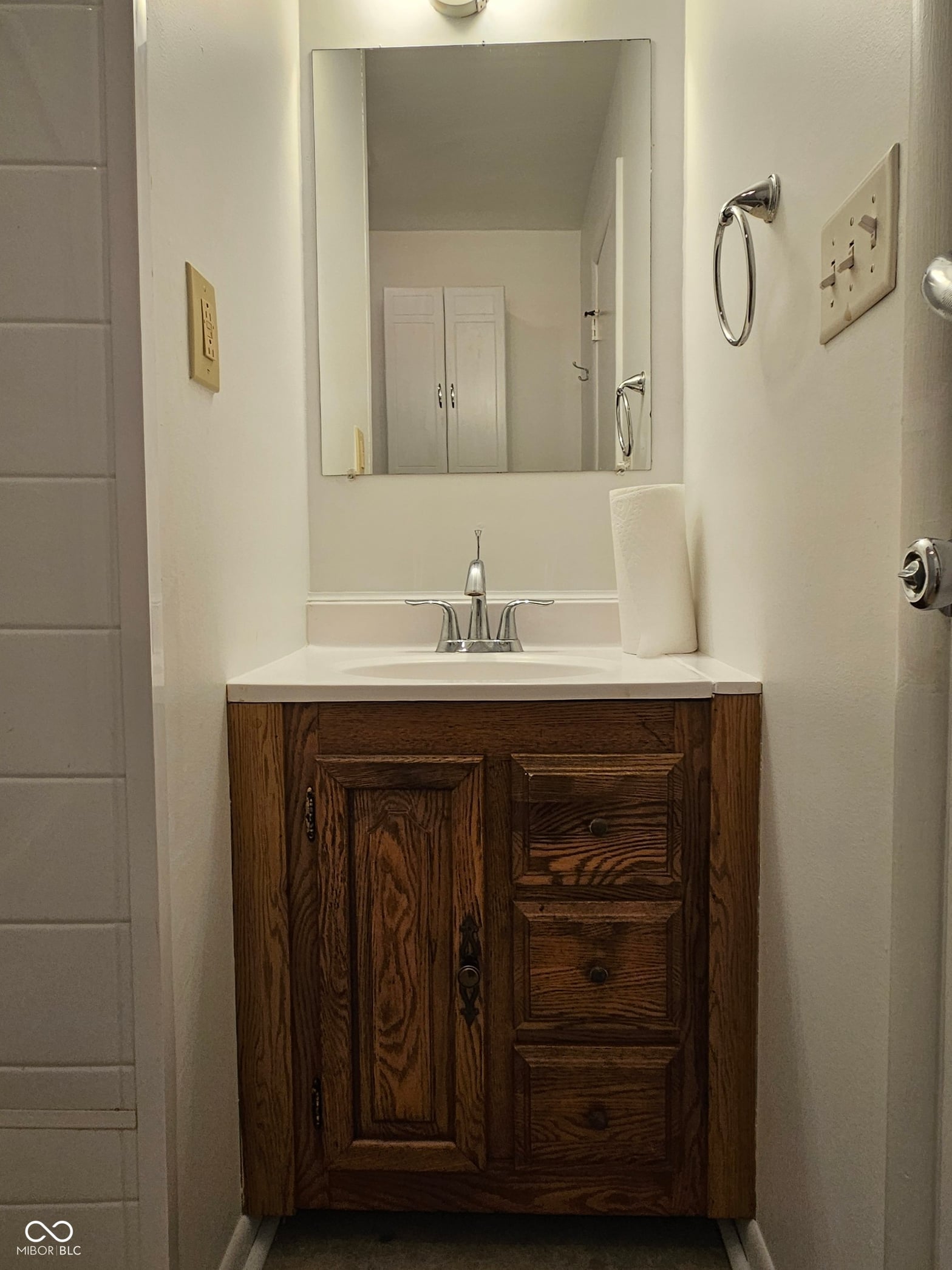 Primary bathroom at 100 S Blake Street, Sheridan, IN — Elegant bathroom with wood vanity and marble countertop.