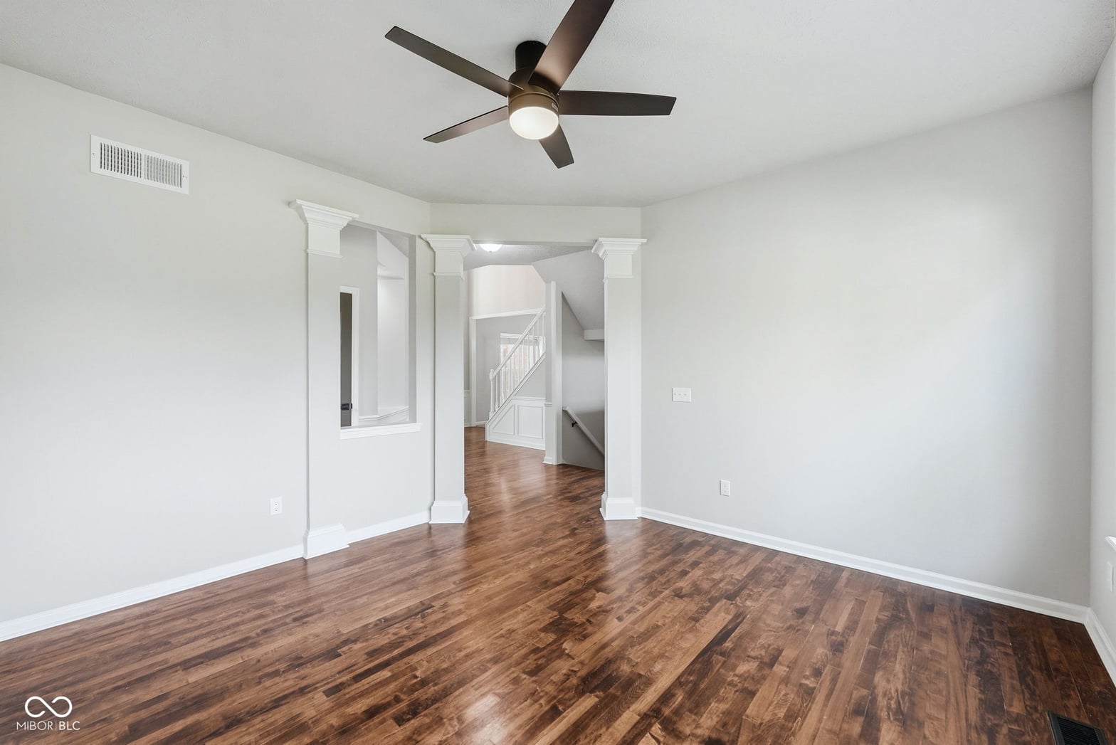 Bright open living space with beautiful hardwood floors.