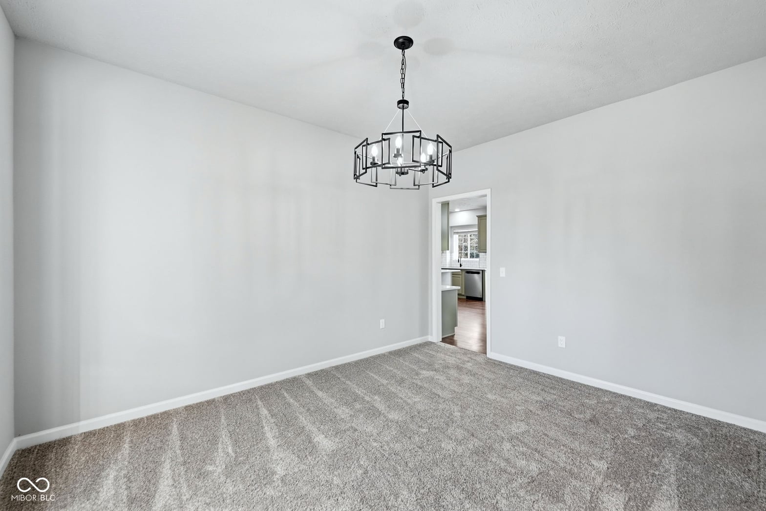 Bright, open dining area with modern pendant fixture.