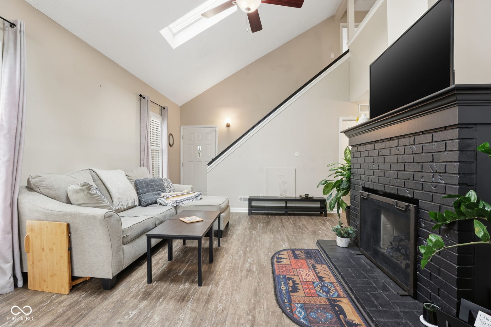 Bright family room with skylights and fireplace.