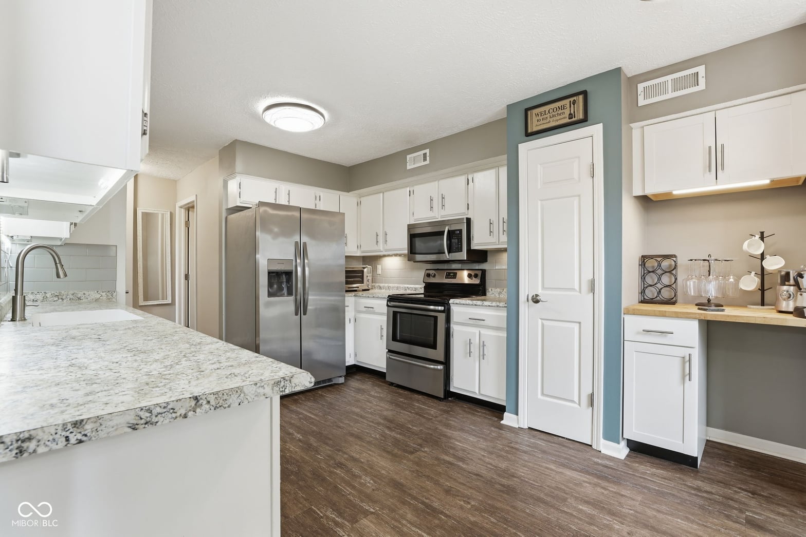 Modern renovated kitchen with granite and stainless steel.