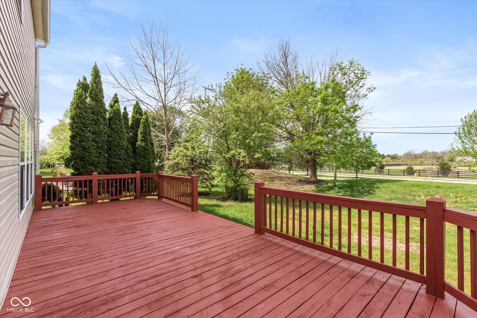 Spacious deck with scenic pastoral views and professional landscaping.
