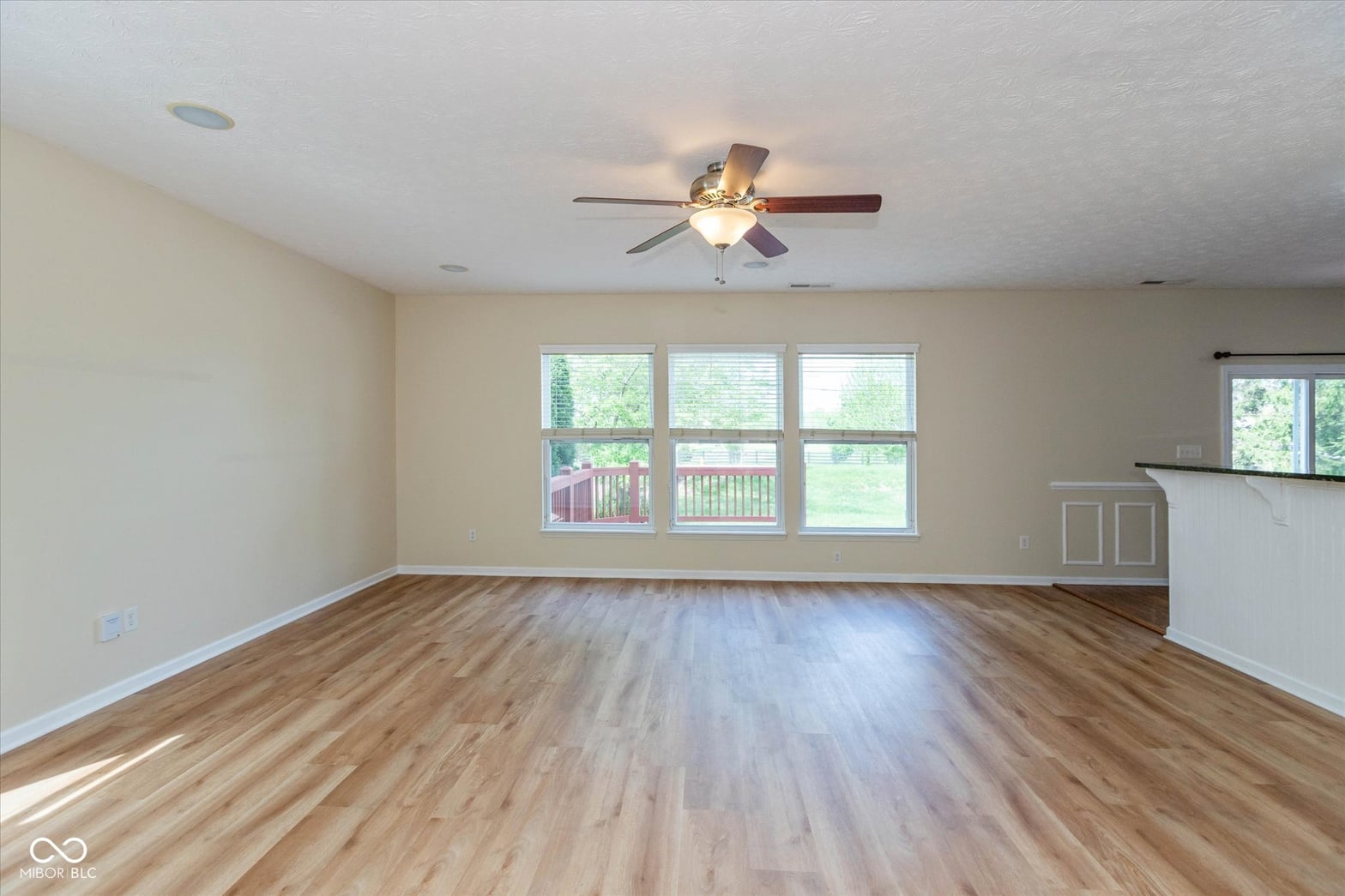 Bright living room with hardwood floors and abundant natural light.