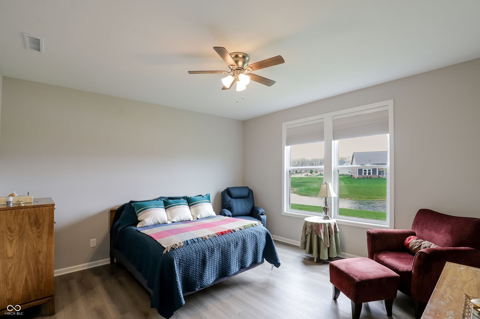 Bright primary bedroom with patio doors and modern finishes.
