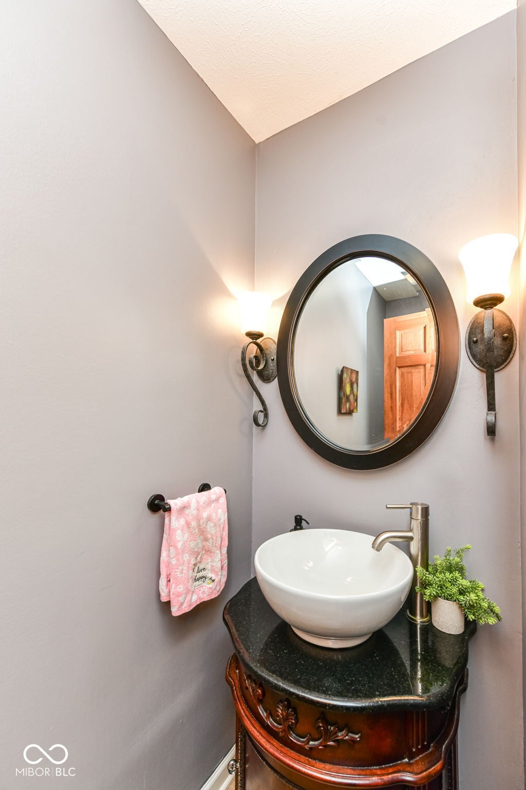 Updated half bath with vessel sink and designer touches.