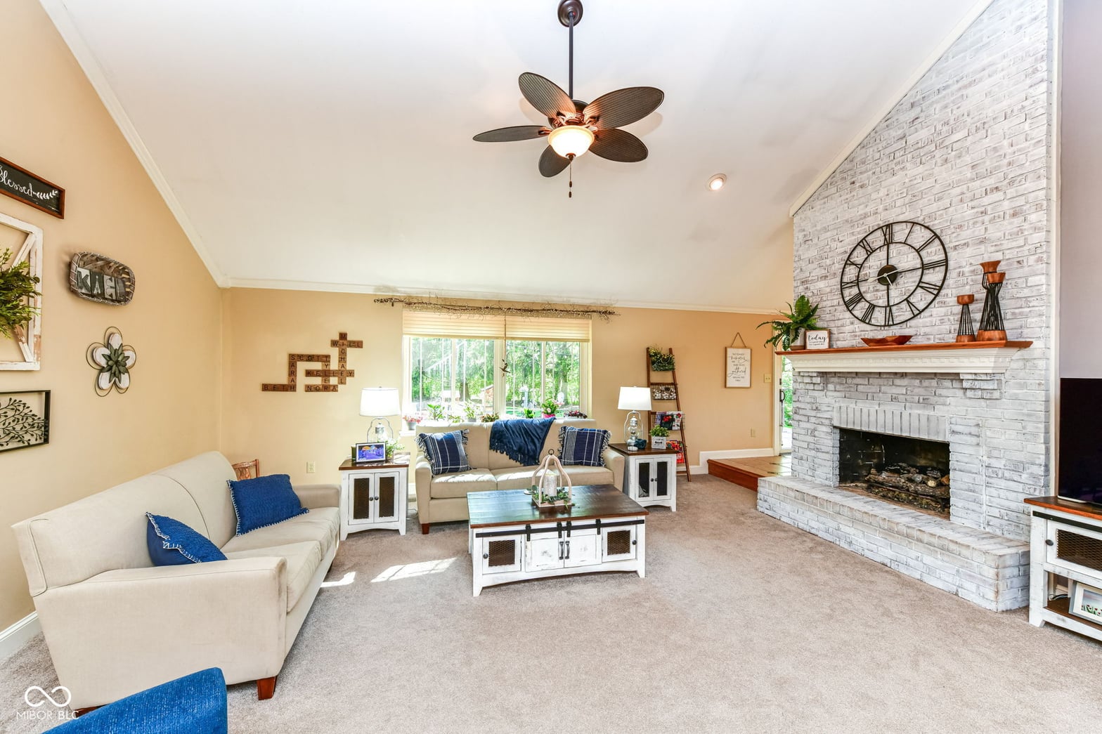 Spacious family room with impressive fireplace and vaulted ceilings.