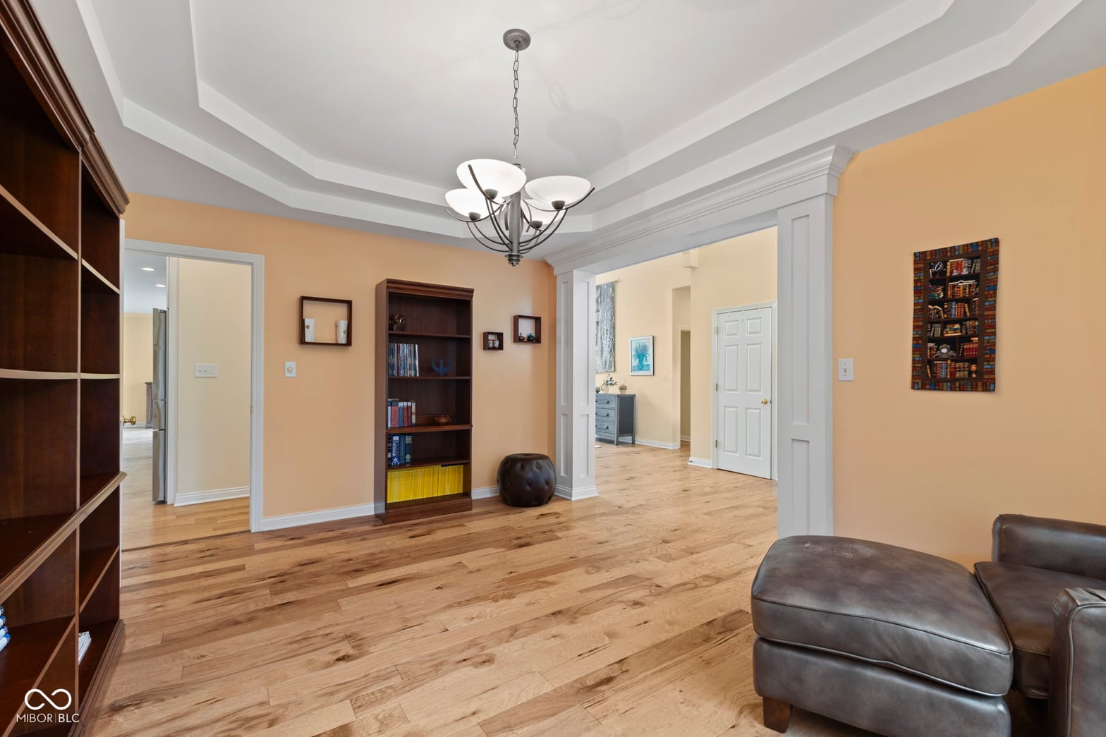 Spacious family room with hardwood floors and tray ceiling.