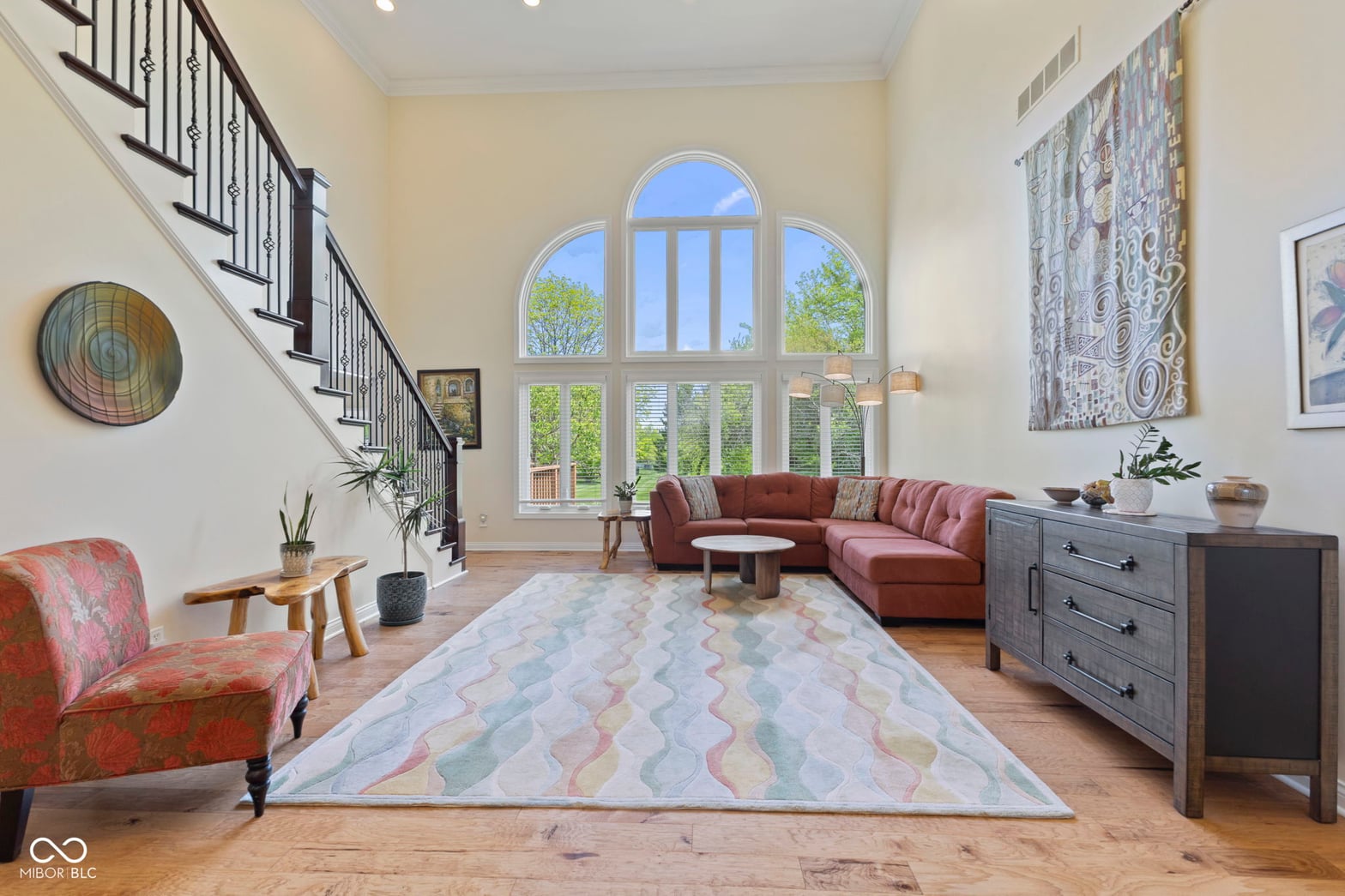 Stunning two-story living space with dramatic arched windows.