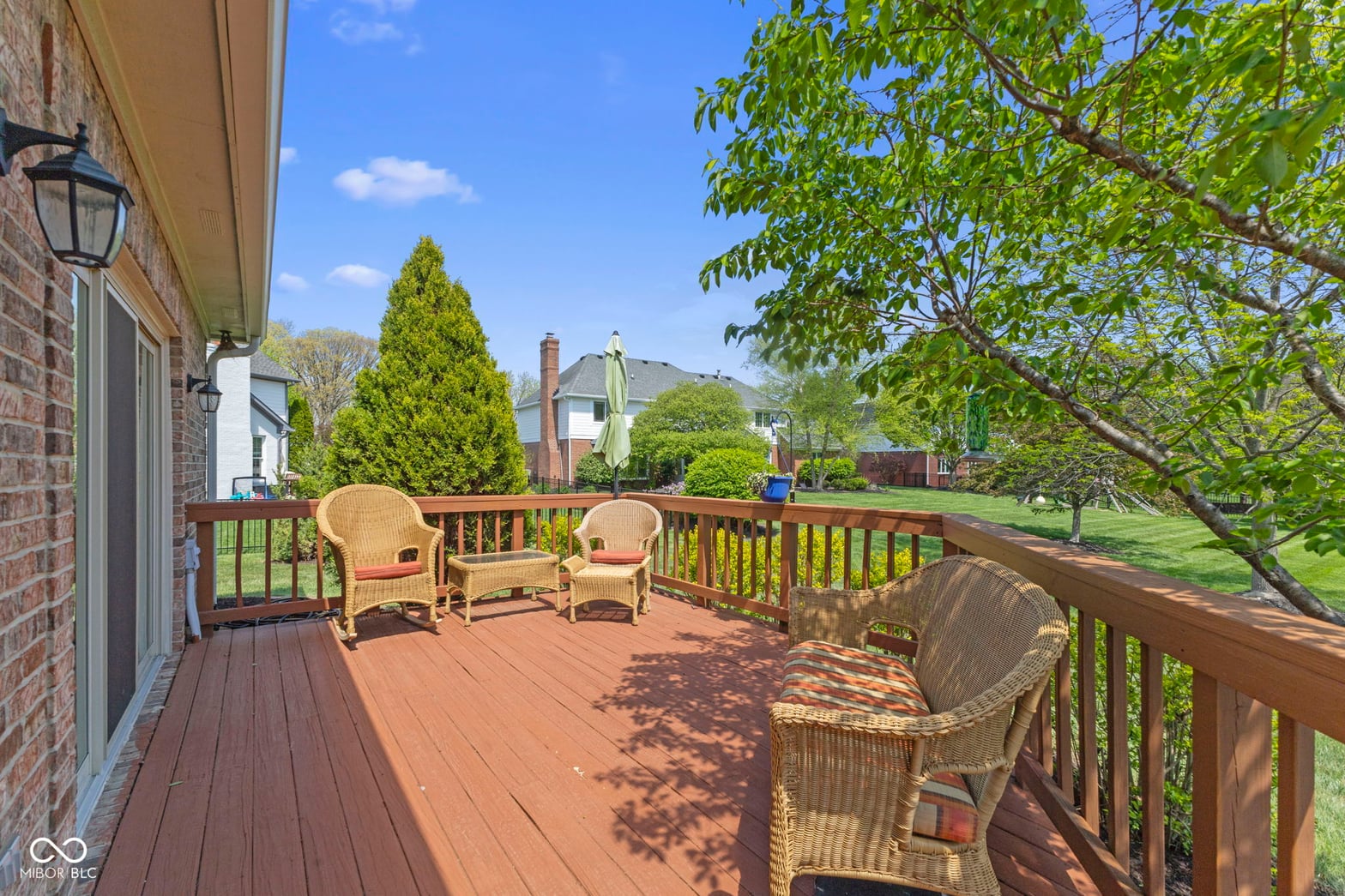 Expansive deck with mature trees and serene backyard views.