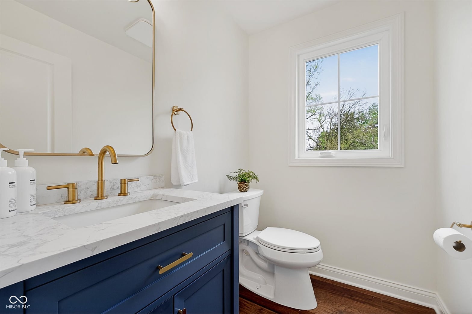 Luxurious primary bath with marble and brass accents.