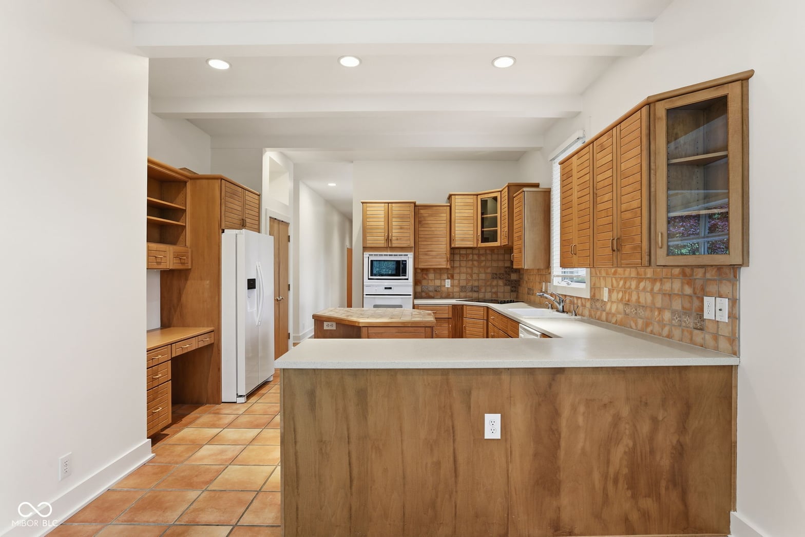 Traditional kitchen with wood cabinetry and island.