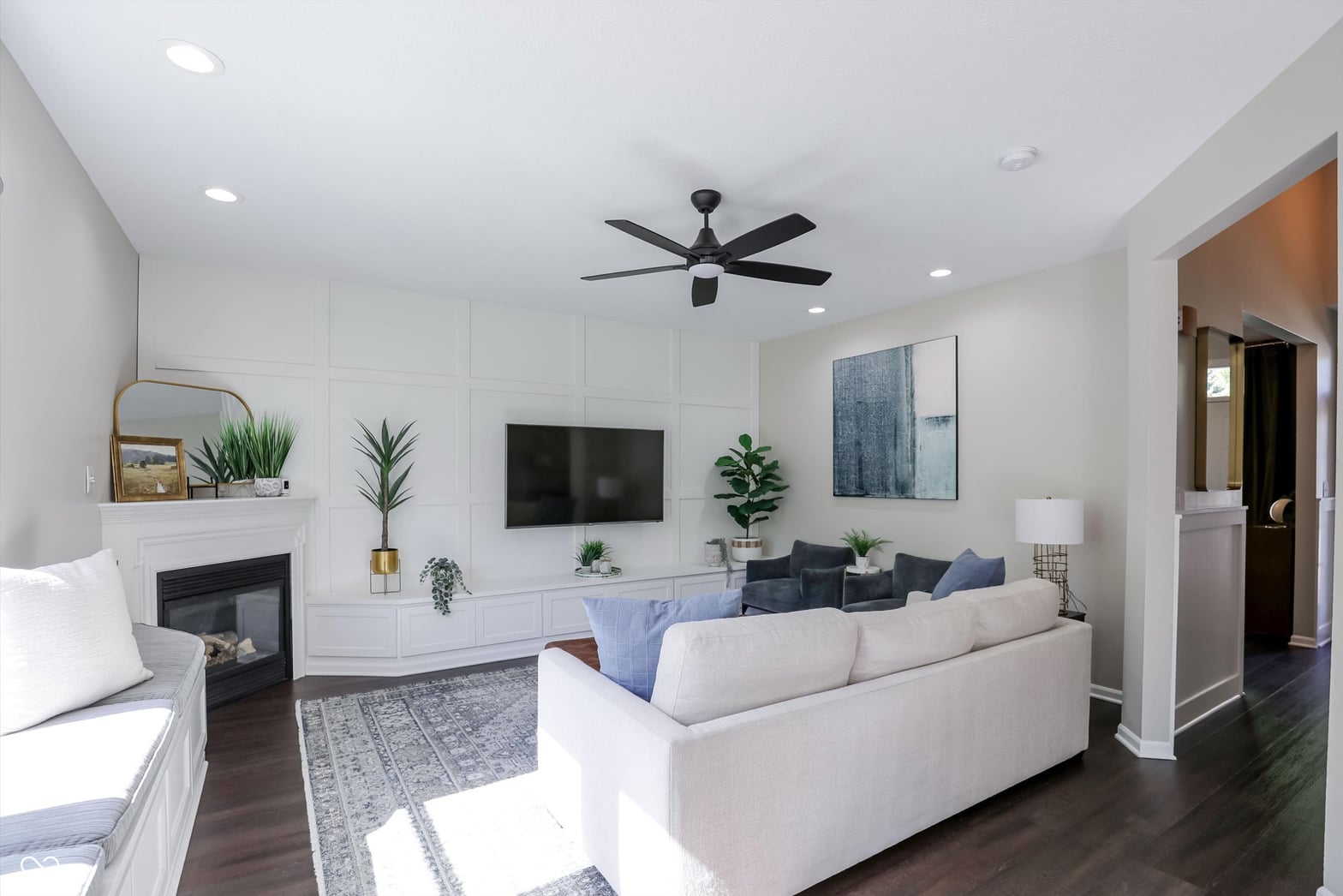 Modern family room with fireplace and built-in entertainment center.