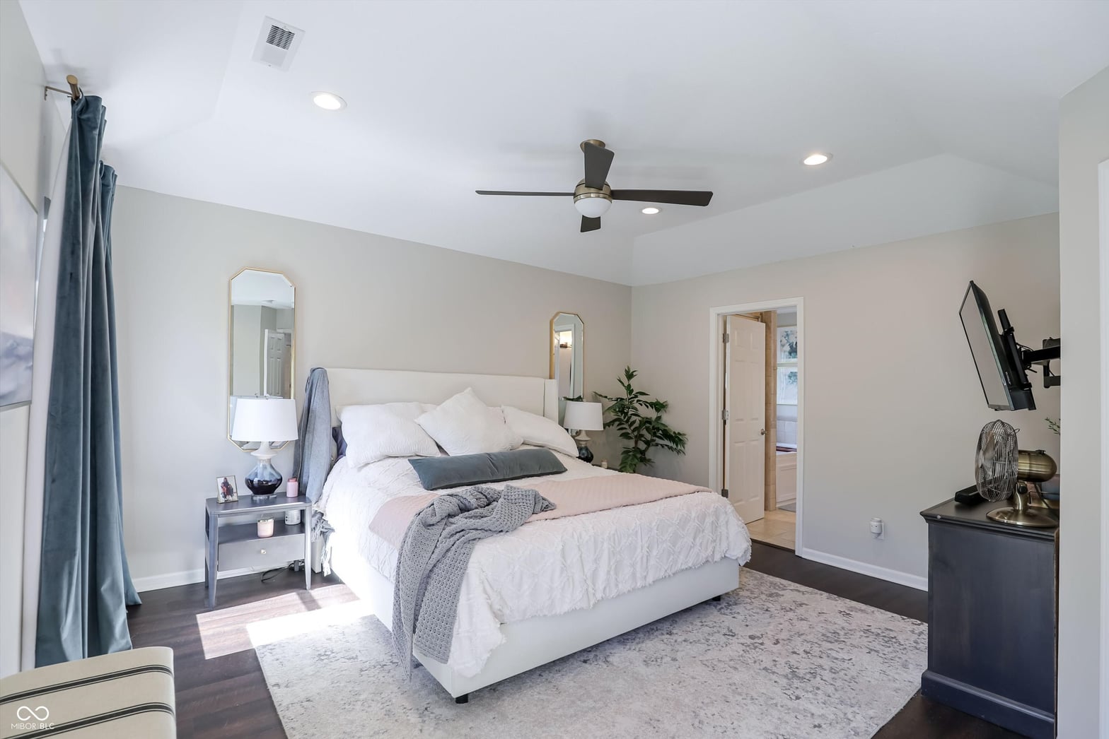 Spacious primary suite with hardwood floors and ensuite access.